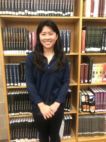 Jenny Kim, HHS senior, poses in the HHS library after being named April Student of the Month. She plans on attending the University of Virginia to study neuroscience and art. (Broadcaster/ Claire Sheppard)
