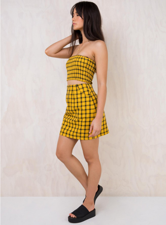 Chanel Cher Horowitz’s signature yellow plaid look with this tube top/skirt set from Princess Polly. The classic style has a modern spin with a high waisted A-line mini skirt and trendy smocked tube top. Style this set with platform sandals to add to the look. (Princess Polly)