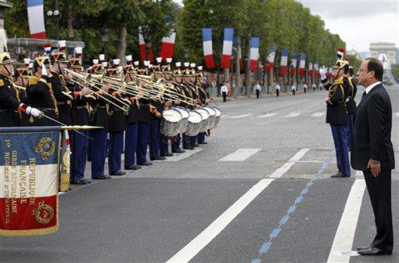 French President Francois Hollande, right, reviews the Republican Guard during the military parade on the Place de la Concorde during Bastille Day parade in Paris, Saturday, July 14, 2012. Bastille day is celebrated each year to acknowledge the French liberation from King Louis XVI. (AP Photo/Benoit Tessier, Pool)

