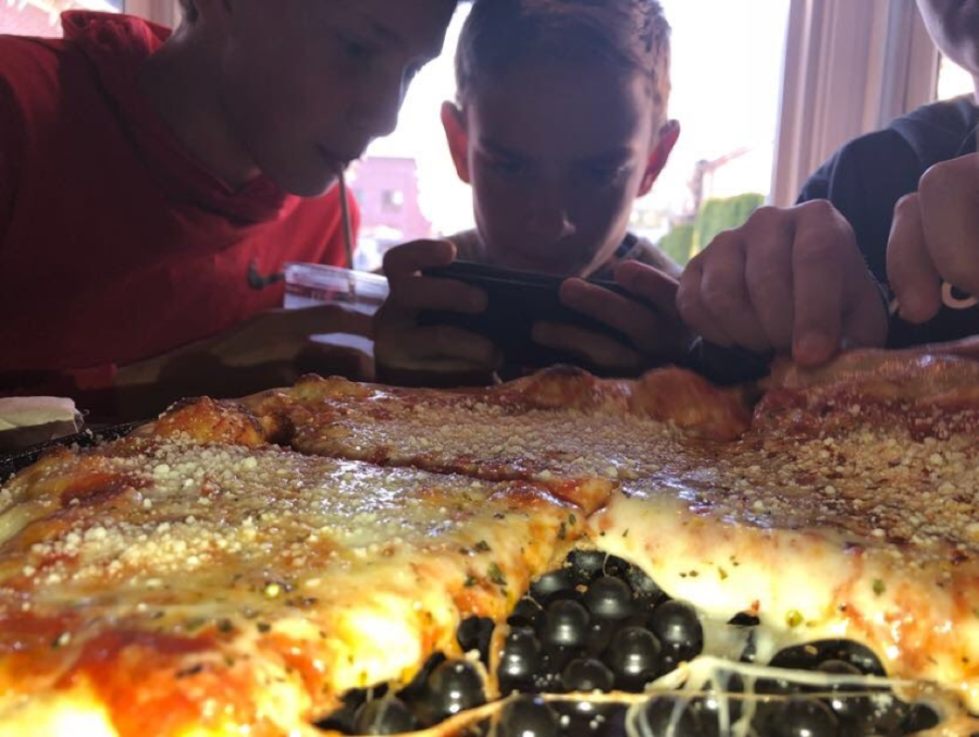 Kaden Farrell, Jake Moyer, and Ryder Reitz all enjoy Phillip Arthurs new brick oven pizza on April 27, 2018. Phillip Arthurs was closed for about three months while getting the brick oven. (Broadcaster/Keeley Farrell)