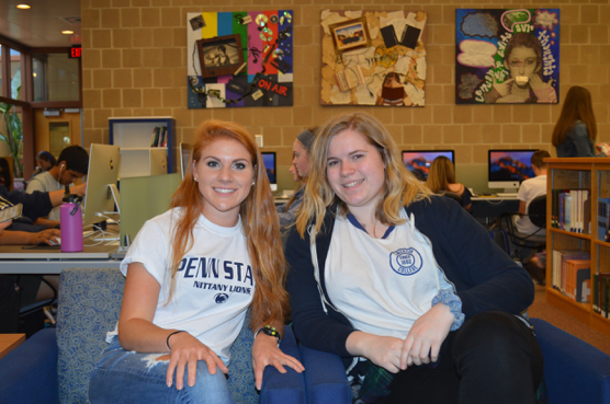 Grace Murray and Molly Reeves, HHS seniors, show off their college t-shirts. Murray is going to Penn State University and Reeves is going to Emerson College. (Broadcaster/Claire Sheppard)