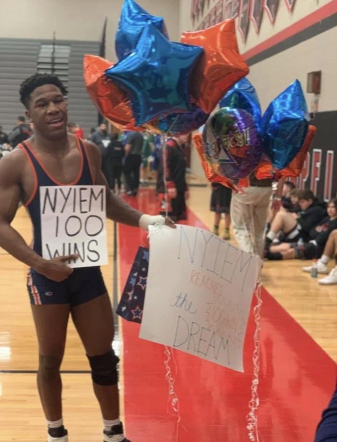 Nyiem Flucas celebrates after his 100th career win Saturday, February 16. Flucas ended his high school career with a 106-38 record. (Submitted/Nyiem Flucas)