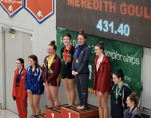 Meredith Gould stands on the first place stop atop the podium at the PA Districts meet on February 23rd, 2019. Gould has qualified for the State meet for three consecutive years, but this year marks her first time being named District Champion. (Via/Diana Pugliese)