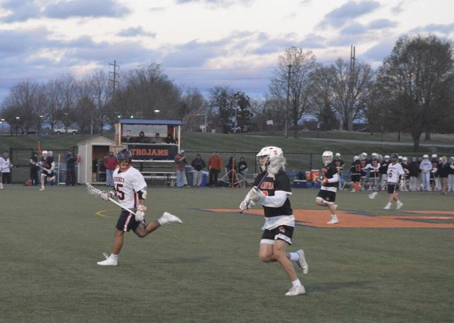 HHS junior Jay Rodriguez (left) plays defense on a Palmyra attacker. The Trojans fell to the Cougars with a score of 11-4. (The Broadcaster/Leah Koppenhaver)
