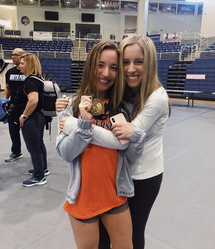 Gould is celebrating her sixth place finish with her sister. This was Gould’s final match as a Trojan. (Submitted by Meredith Gould) 