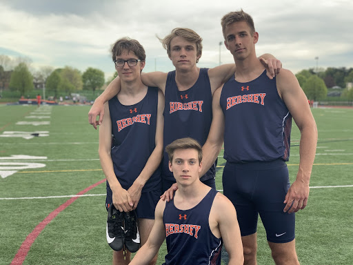 Seniors Mark Suminski (right), Alex Elchev (left), and Chris Cronin (bottom center) stand with teammate Ian Willen during track meet on Tuesday, April 24th. Hershey High Boys Track beat Susquehanna 78 to 72. (Broadcaster/ Emily Massage)