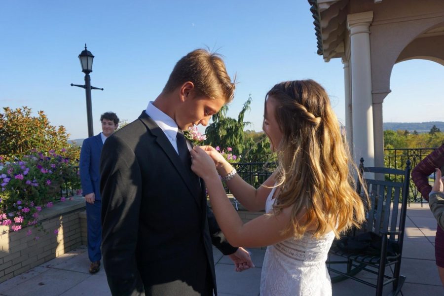 Freshman, Ava Sheppard is putting the boutonniere on her date Mathew Segrave Daly. Sheppard’s white sparkly dress was from Hello Molly. (Broadcaster/Clare Canavan)