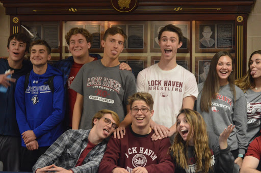 Tanner Updegraff poses with his friends in Lock Haven apparel. Updegraff transferred to Hershey his junior year, and in his first season at HHS, he placed third at the PIAA state tournament. (Broadcaster/Katie Jones)
