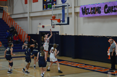 Sophomore Anna Coulter shoots a lay up in the beginning of the game. The Trojans were winning the game after the first quarter of play. (Broadcaster/Katie Jones)