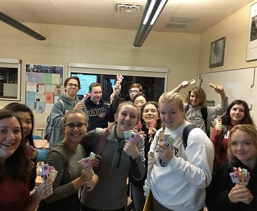 HHS LEAF Club pose for the camera with their fundraiser lollipops. The club sold 100 lollipops to better the environment. (HHS LEAF Club)