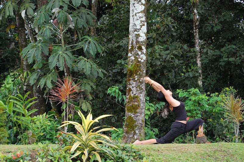 The woman is doing yoga outdoors as a way to stay mindful. Yoga has the ability to prepare you for whatever tasks lie ahead. (Jon Fife/CC By-ND 2.0)