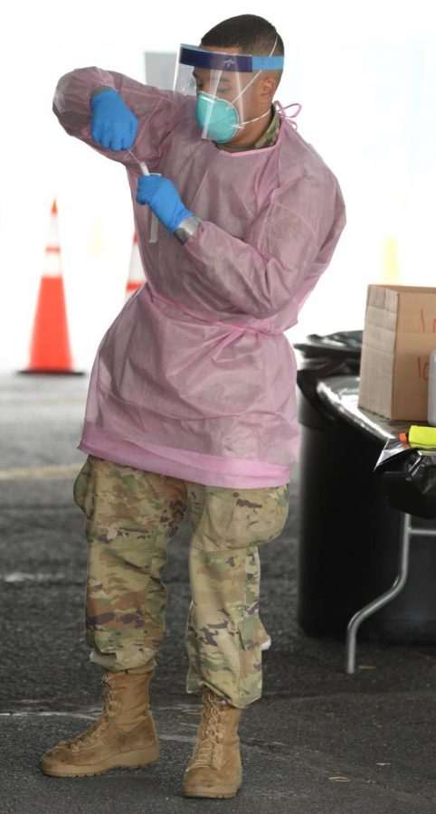 A Combat Medic Specialist from Queens, N.Y., assigned to the New York Army National Guard, secures a swab used to test for COVID-19 infection in Brooklyn, N.Y., April 20, 2020. COVID-19 testing is becoming more advanced in hopes to aid in reopening society. (U.S. Air National Guard photo by Senior Airman Sean Madden)