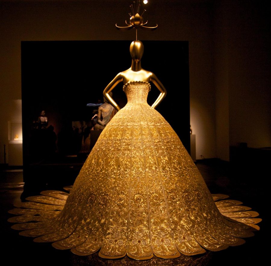 Pictured is Metropolitan Museum of Arts exhibit, China: Through the Looking Glass, specifically: designer Guo Peis dress.  The Met Gala will occur on September 15, 2021.  (Lydia Liu/CC BY 2.0)