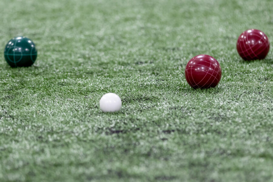 Pictured is a white pallina bracketed by the red and blue bocce.  HHS launched its coed varsity bocce team in December 2022.  (Marco Catini/CC BY-NC-ND 2.0)