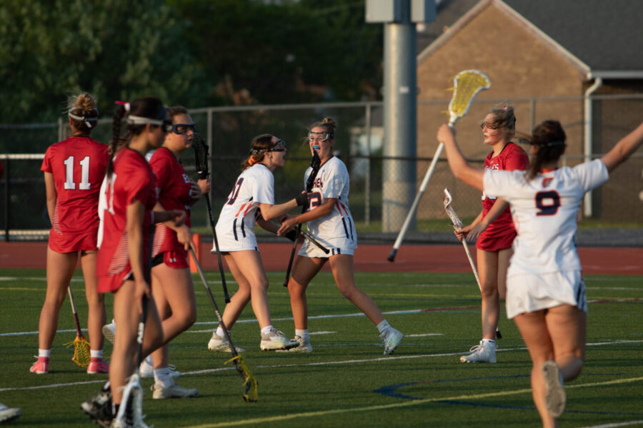 Members of the Hershey Girls Lacrosse Team celebrate a goal by Emily Beitzel in the second half of the Mid-Penn Championship game. The Trojans exploded in the second half, outscoring Cumberland Valley 8-1 in the second period. (Broadcaster/Joey Owsley)