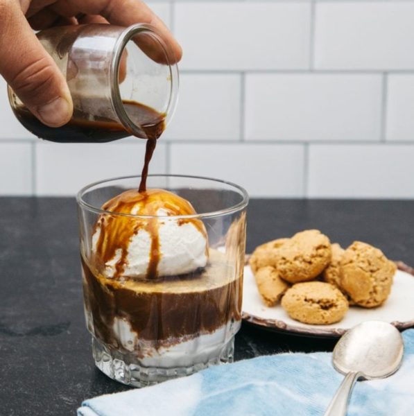 An espresso shot is poured into a scoop of vanilla ice cream with cookies in the background. This is called an affogato, a traditional Italian dessert. (Jaime Thrower/Taste of Home) 
