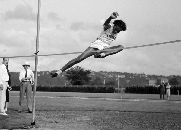 Alice Coachman winning a high jump event. In 1948 she became the first African American Women to win a gold medal for track and field. 