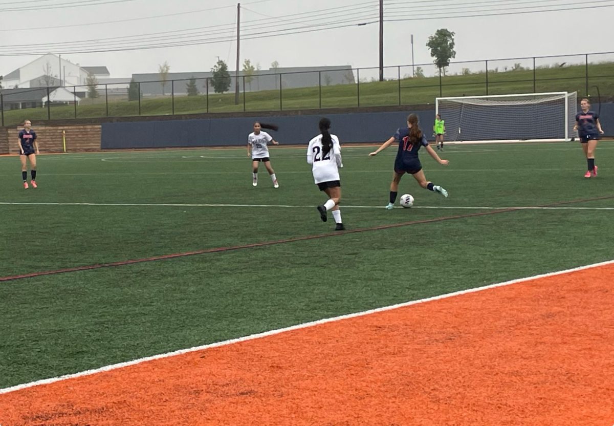 Sophomore Campbell Stover passes the ball to her teammate Sabrina Stasz. The Trojans won 13-0 on Wednesday, September 25. (Vivienne Dotts/The Broadcaster)