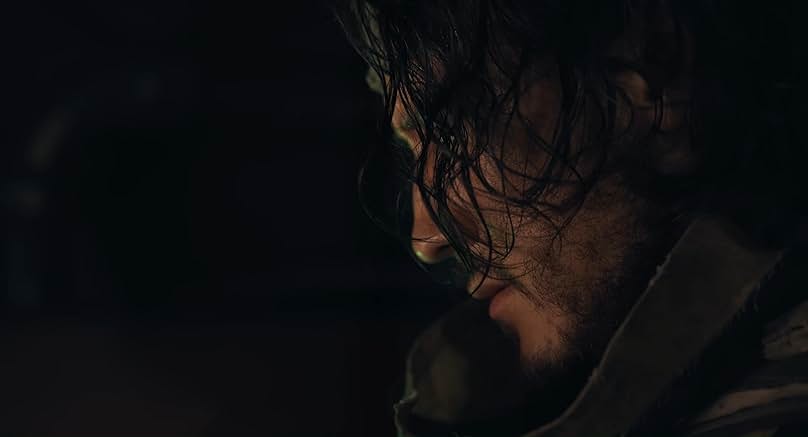 Simon stares downward, his face tense and shadowed as the weight of the mission closes in. He was sent alone into the submarine to explore the blood ocean with little knowledge of what waited below. (Markiplier Studios)