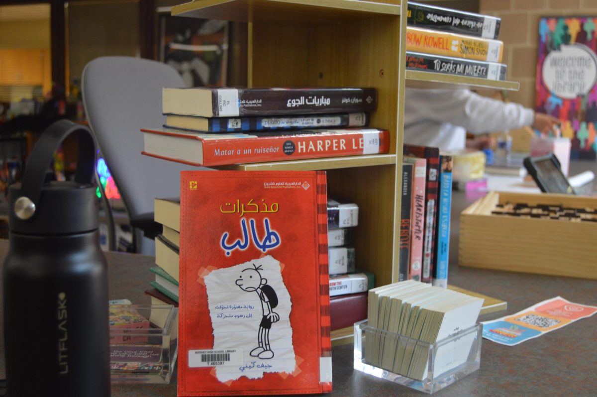 Books in multiple languages are displayed on a shelf at Hershey High School’s library on April 30, 2026. The variety reflects how modern libraries aim to represent diverse readers while still promoting traditional reading. (Broadcaster/Sophy Ukadike)
